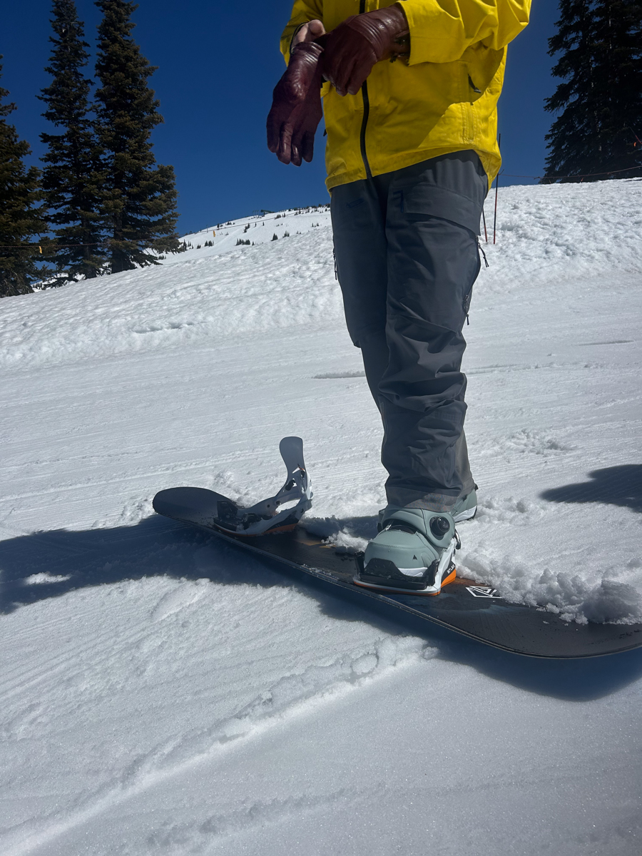 Man Standing on Snowboard Bindings