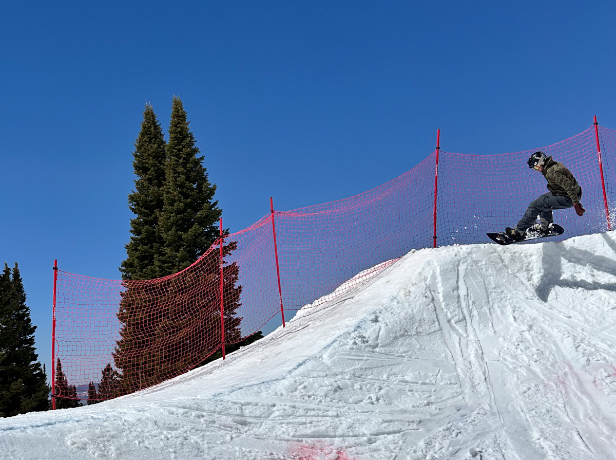 Man Catching Snowboard Air