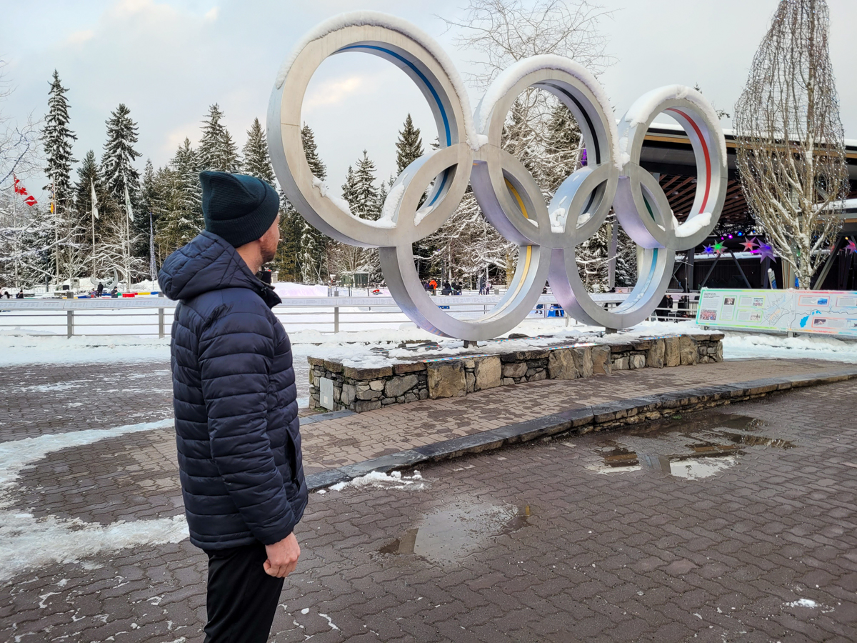 Man Standing By Olympic Arches in Whistler
