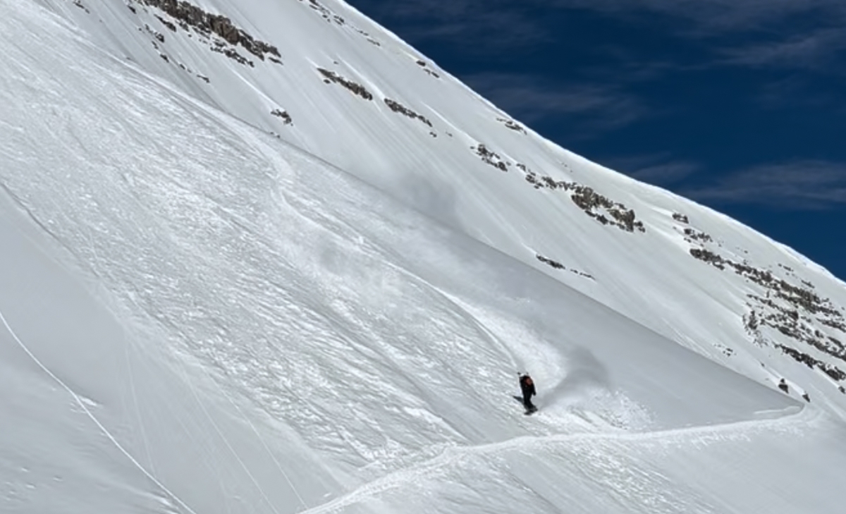 Man Snowboarding Big Mountain Terrain