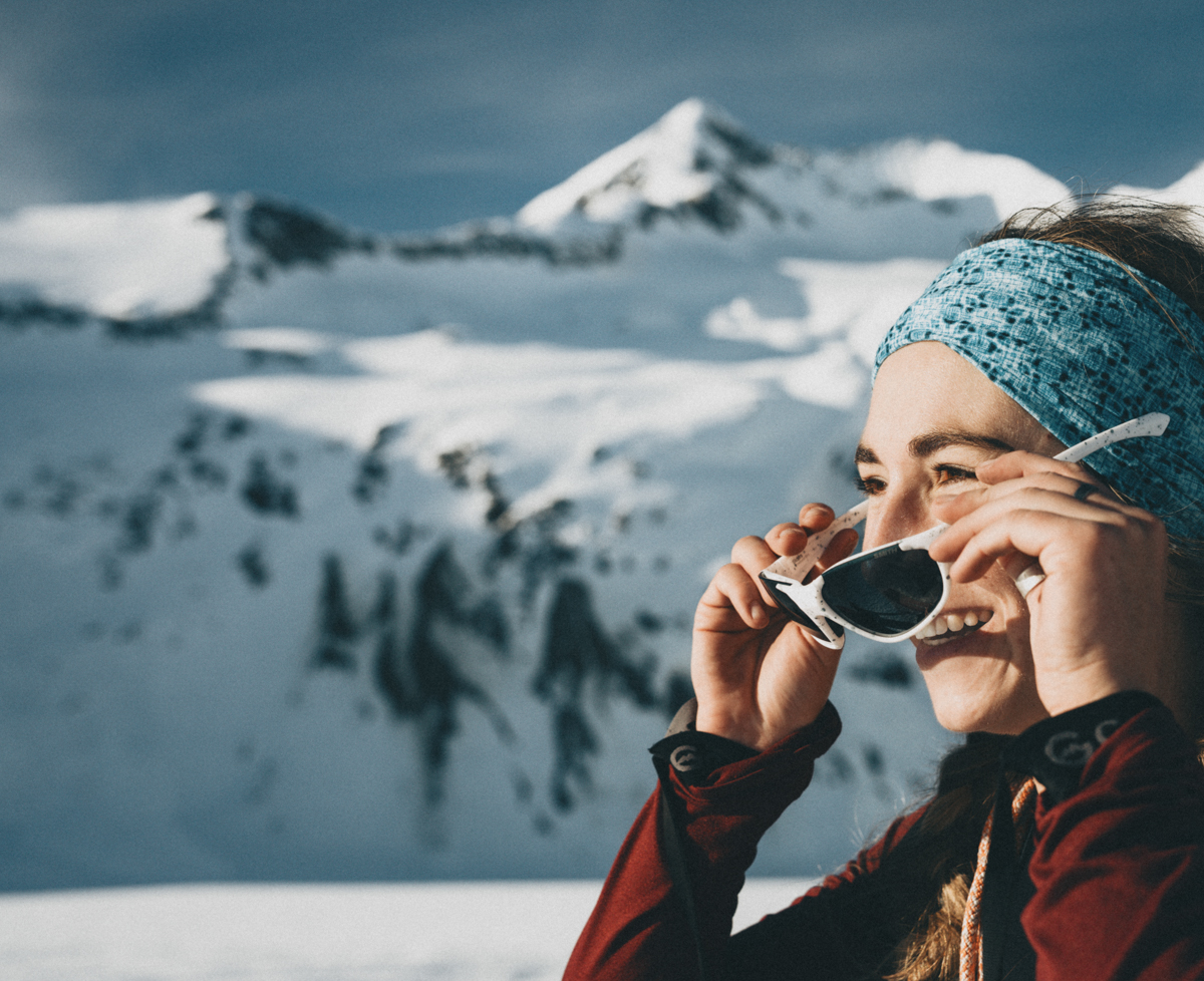 Women wearing white sunglasses, testing the Smith Sliders in the Mountains