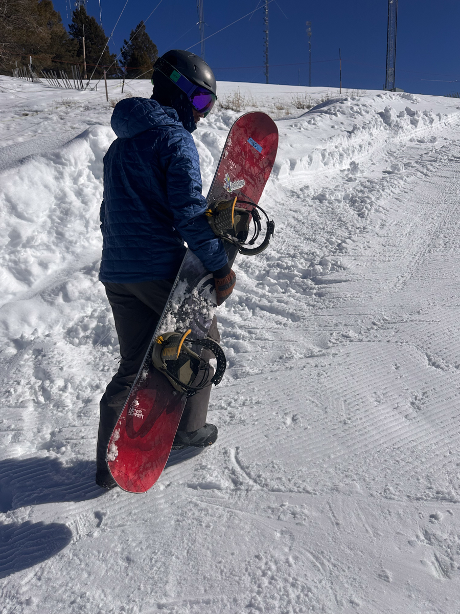 Man Hiking with Snowboard