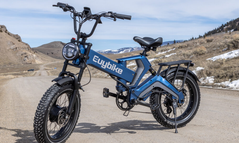 Side profile of the blue Euybike K6 Pro folding electric bike parked on a paved street in Jackson, Wyoming.
