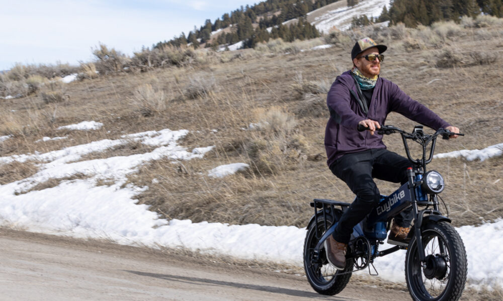 A rider testing the Euybike K6 Pro e-bike on a gravel dirt road in the Bridger-Teton National Forest near Jackson, WY.