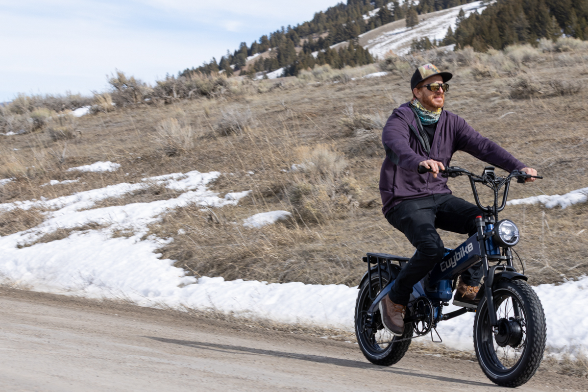 A rider testing the Euybike K6 Pro e-bike on a gravel dirt road in the Bridger-Teton National Forest near Jackson, WY.