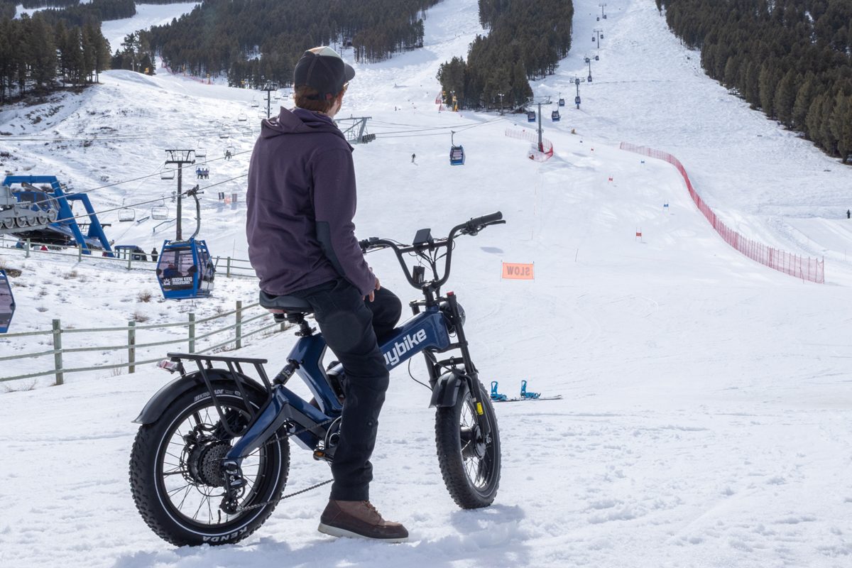 A rider sitting on the Euybike K6 Pro e-bike at the base of a ski resort in Jackson Hole.