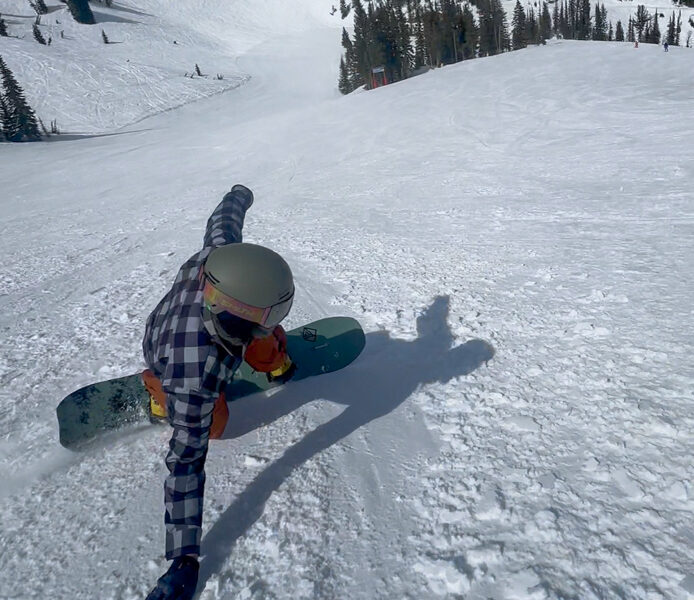 2027 K2 Commonwealth Snowboard carving through deep powder and variable terrain at Jackson Hole Mountain Resort.