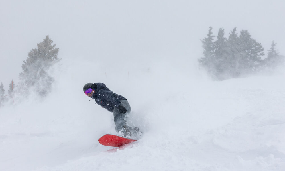 Deep powder snowboarding with the red-based Korua Transition Finder during a Teton storm cycle.
