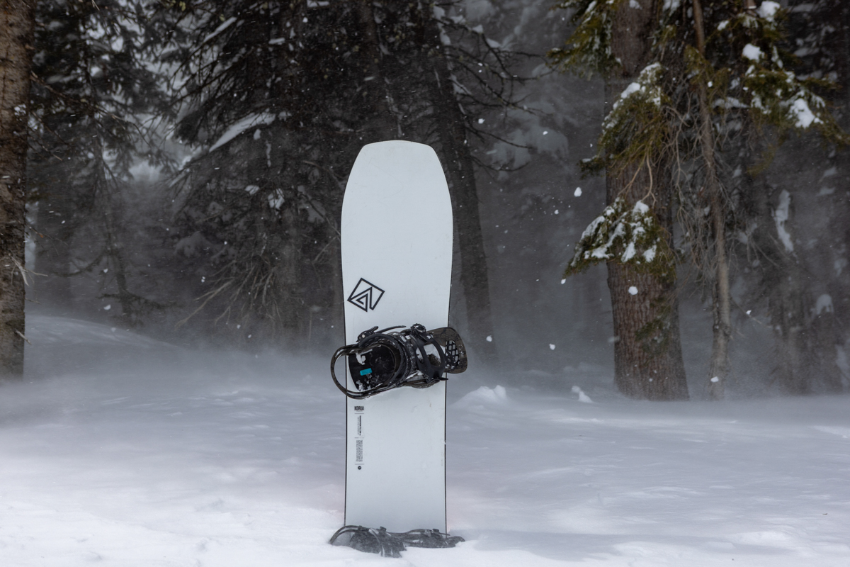 White Korua Transition Finder Snowboard standing upright in deep powder during TETON Tested at Jackson Hole.