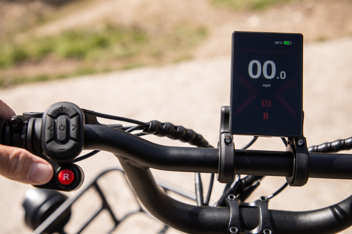 Close-up of the Mooncool TK2 handlebars featuring the 3.5-inch TFT color display and reverse gear controls.
