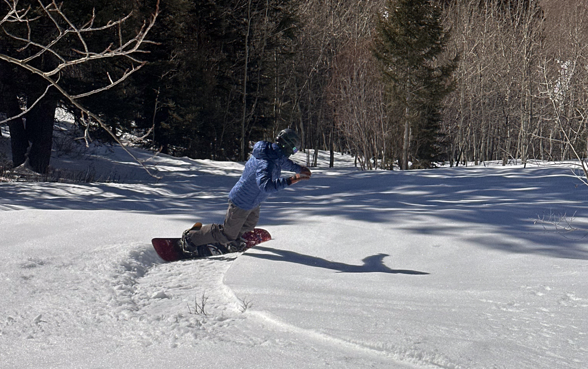 Man Snowboarding in Patagonia Mid Layer Puffy Jacket