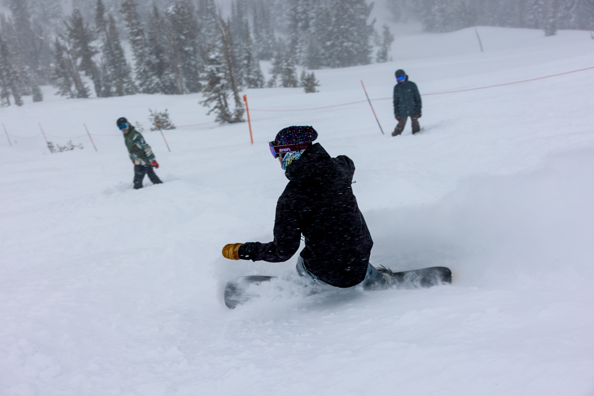 Man Snowboarding Deep Powder