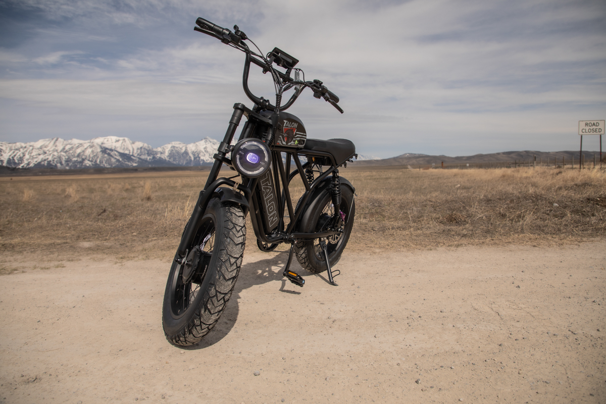 A rugged Talon E-Bike T87 Dual Motor parked on a dirt road in Jackson, Wyoming, with the snow-capped Teton Range standing tall in the background