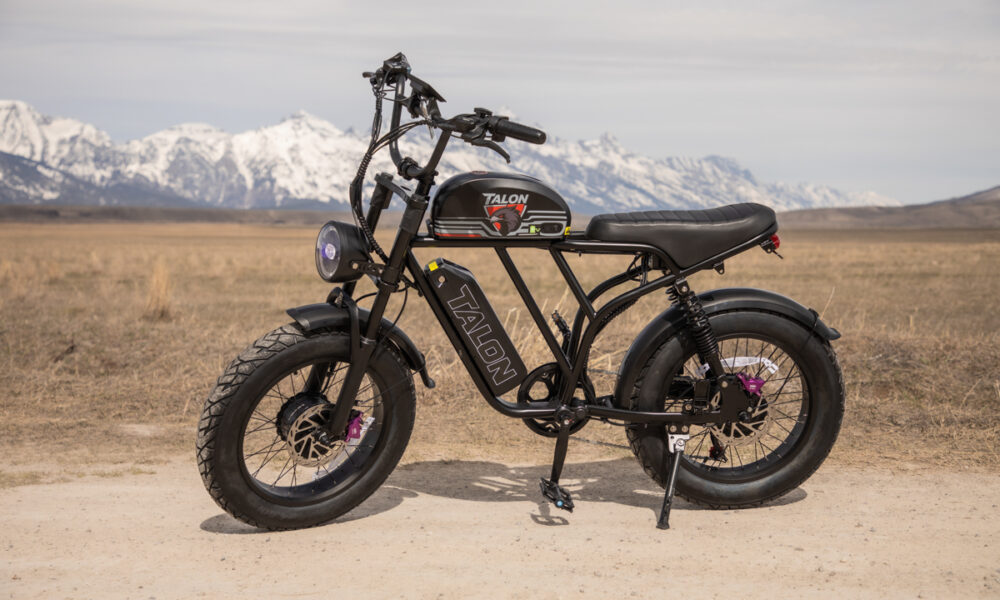 A rugged Talon E-Bike T87 Dual Motor parked on a dirt road in Jackson, Wyoming, with the snow-capped Teton Range standing tall in the background