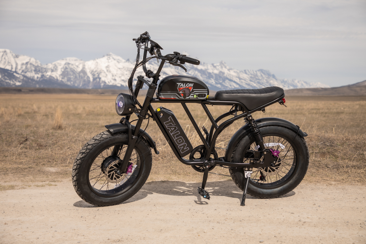 A rugged Talon E-Bike T87 Dual Motor parked on a dirt road in Jackson, Wyoming, with the snow-capped Teton Range standing tall in the background