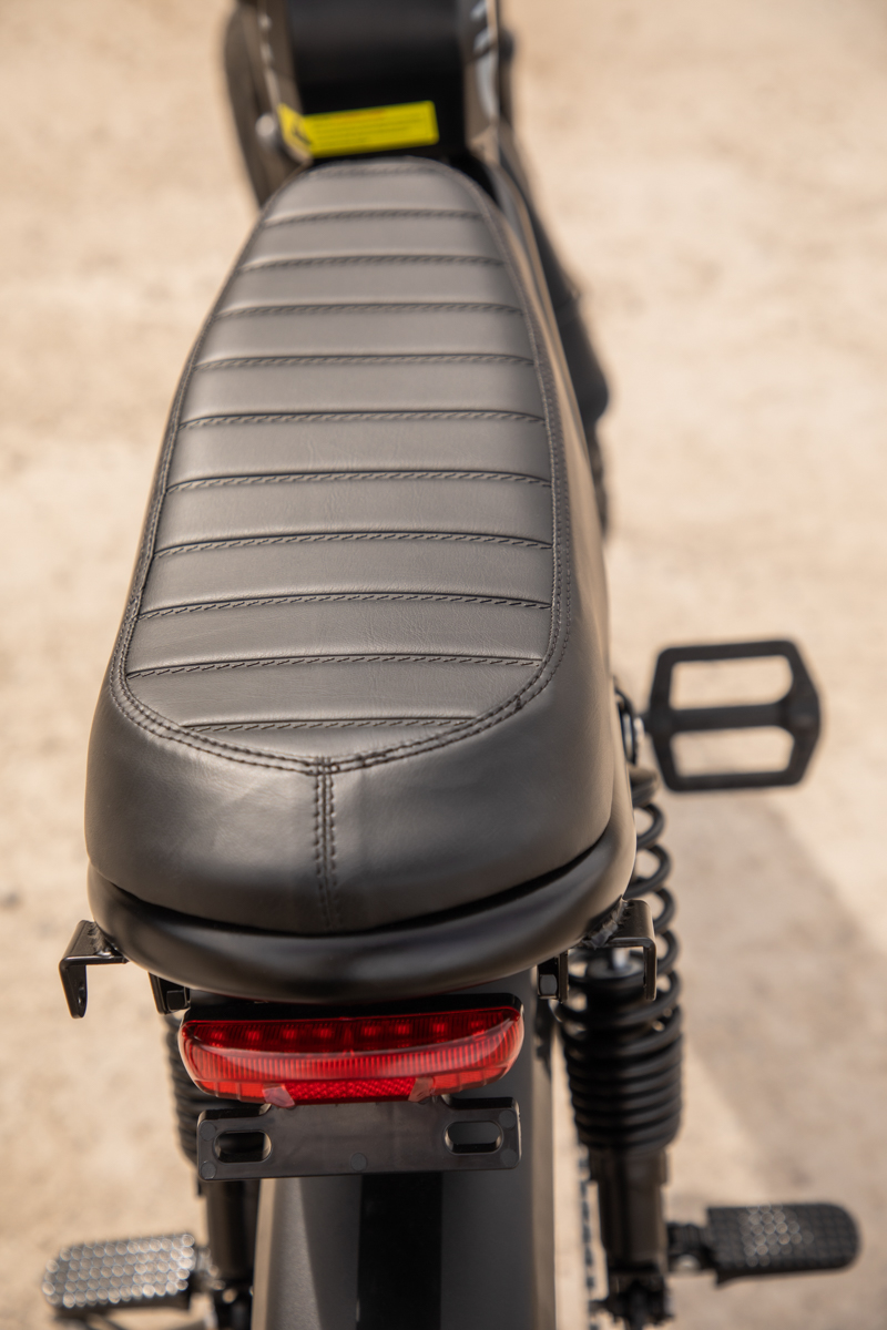 Rear view of the Talon T87 Dual Motor E-Bike, highlighting the long moped-style leather seat and heavy-duty dual rear suspension, built for rugged dirt roads.