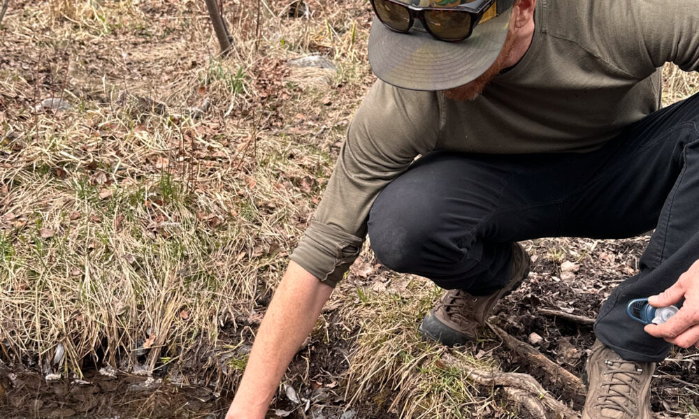 Mike Hardaker TETON Testing Water from Slow Moving Stream
