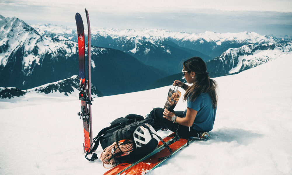 Brigette Takeuchi takes in sweeping Northern Cascade views during a backcountry stop with AlpineAire meals close at hand. | Photo Kelsey Takeuchi Mountain Weekly News