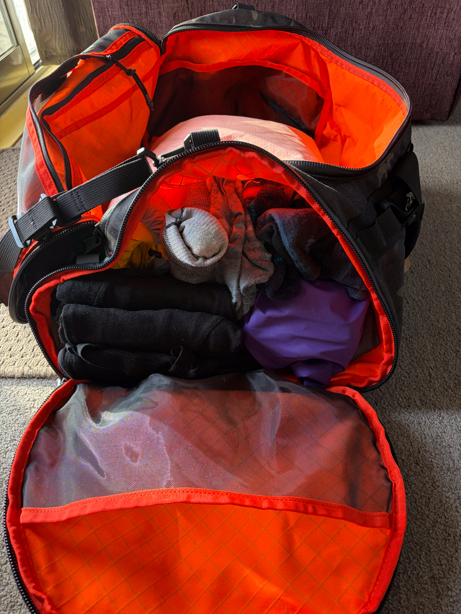 The Brown Buffalo Duffalo duffel bag interior showing separate isolated shoe and dirty laundry compartment with orange waterproof liner
