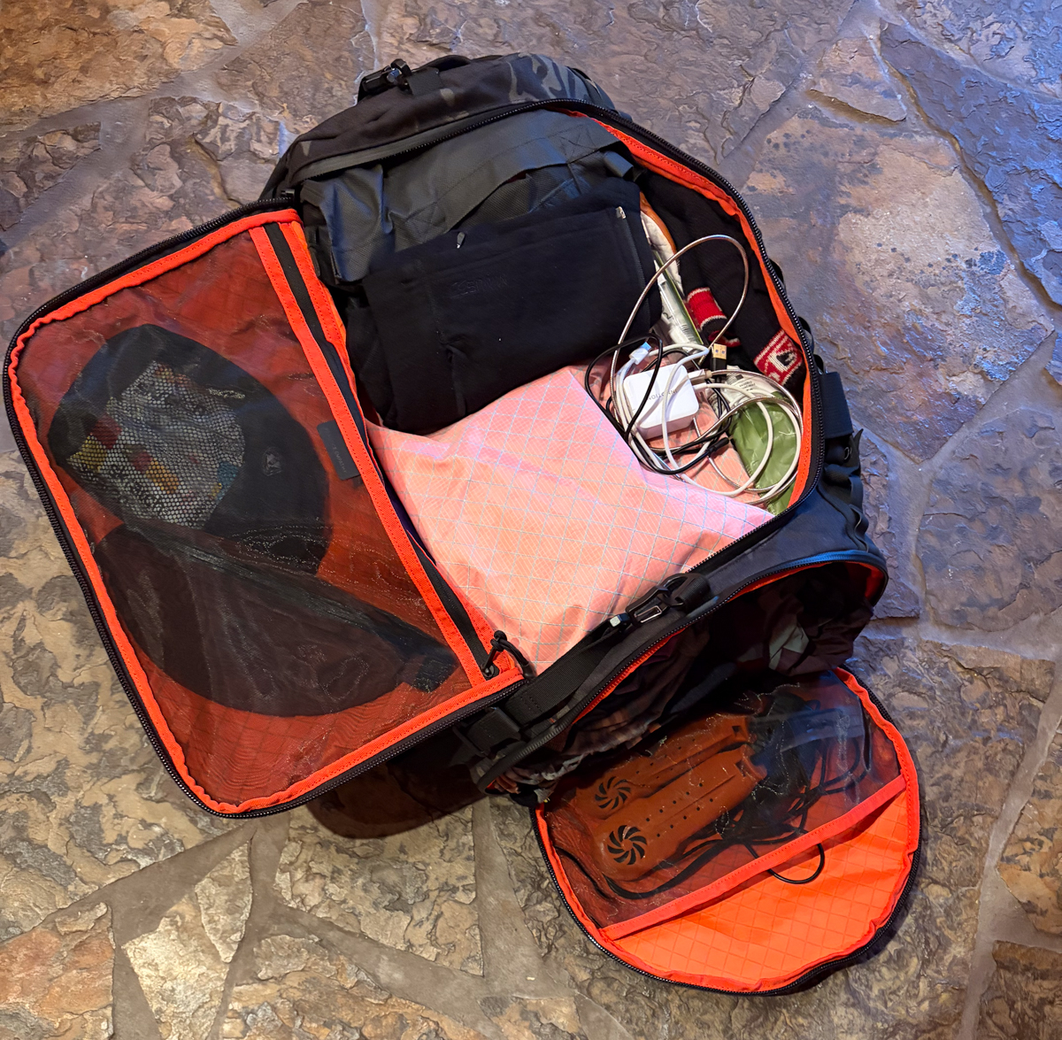 The Brown Buffalo Duffalo minimalist duffel bag interior view highlighting the zippered lid pocket and mesh organizational dividers packed with clothing
