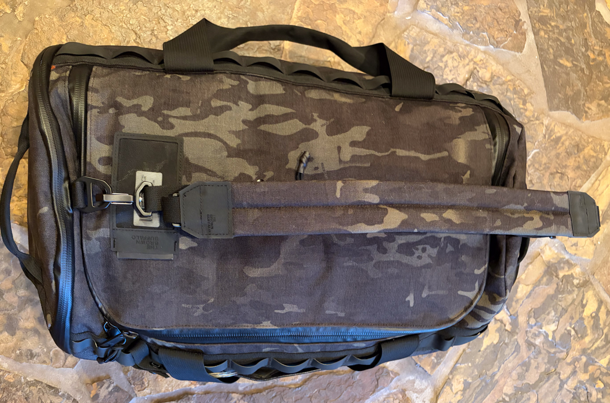 The Brown Buffalo Duffalo travel duffel bag side view showing minimalist tactical camo exterior construction with Cordura fabric shell