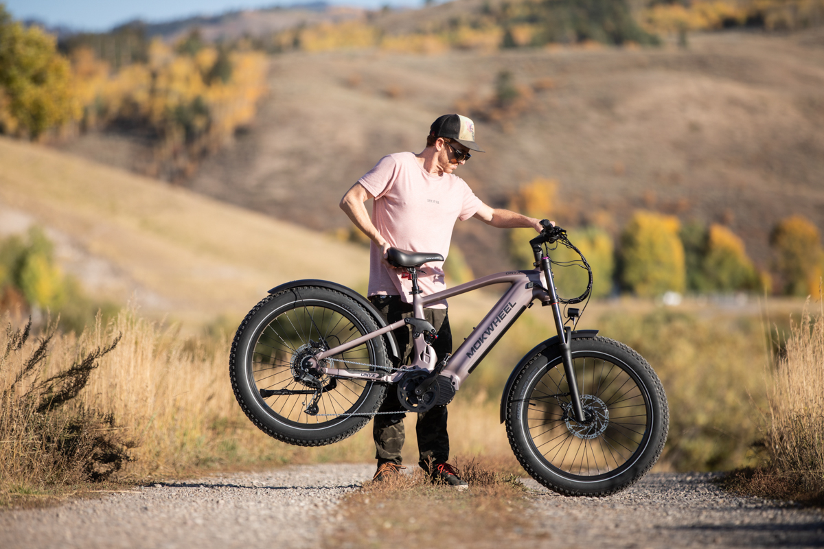 Mountain Weekly News founder Mike Hardaker auditing the frame geometry and full suspension package of the Mokwheel Onyx e-bike on location.