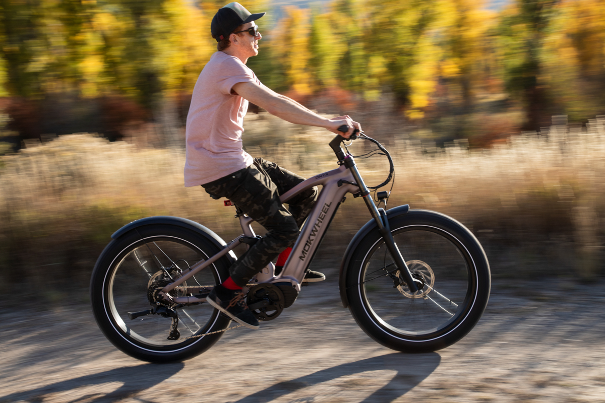 Mokwheel Onyx electric mountain bike being ridden on a dirt road during autumn gear testing in Jackson Hole, Wyoming.