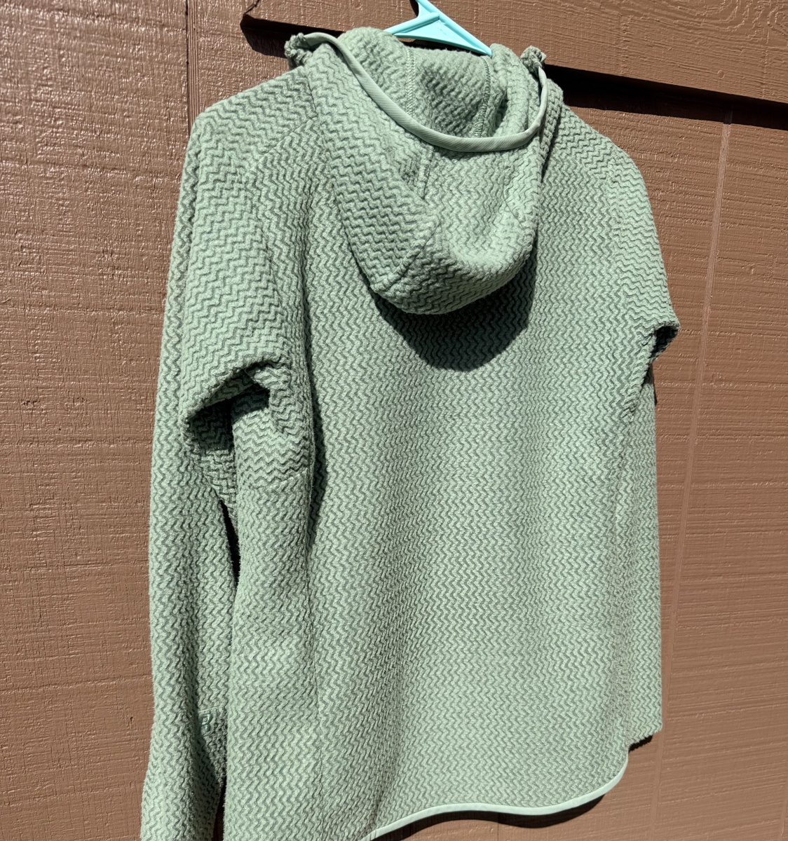Rear view of the Patagonia R1 Air Fleece showing zigzag pattern and hood shape
