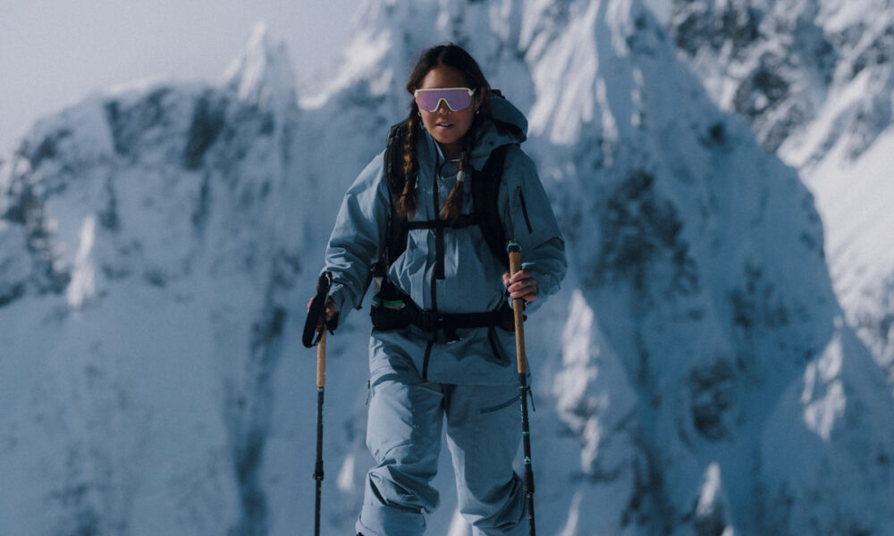 Female backcountry skier skinning in the North Cascades wearing Patagonia Women's PowSlayer Pants, highlighting mobility and GORE-TEX ePE Pro weather protection during a winter tour