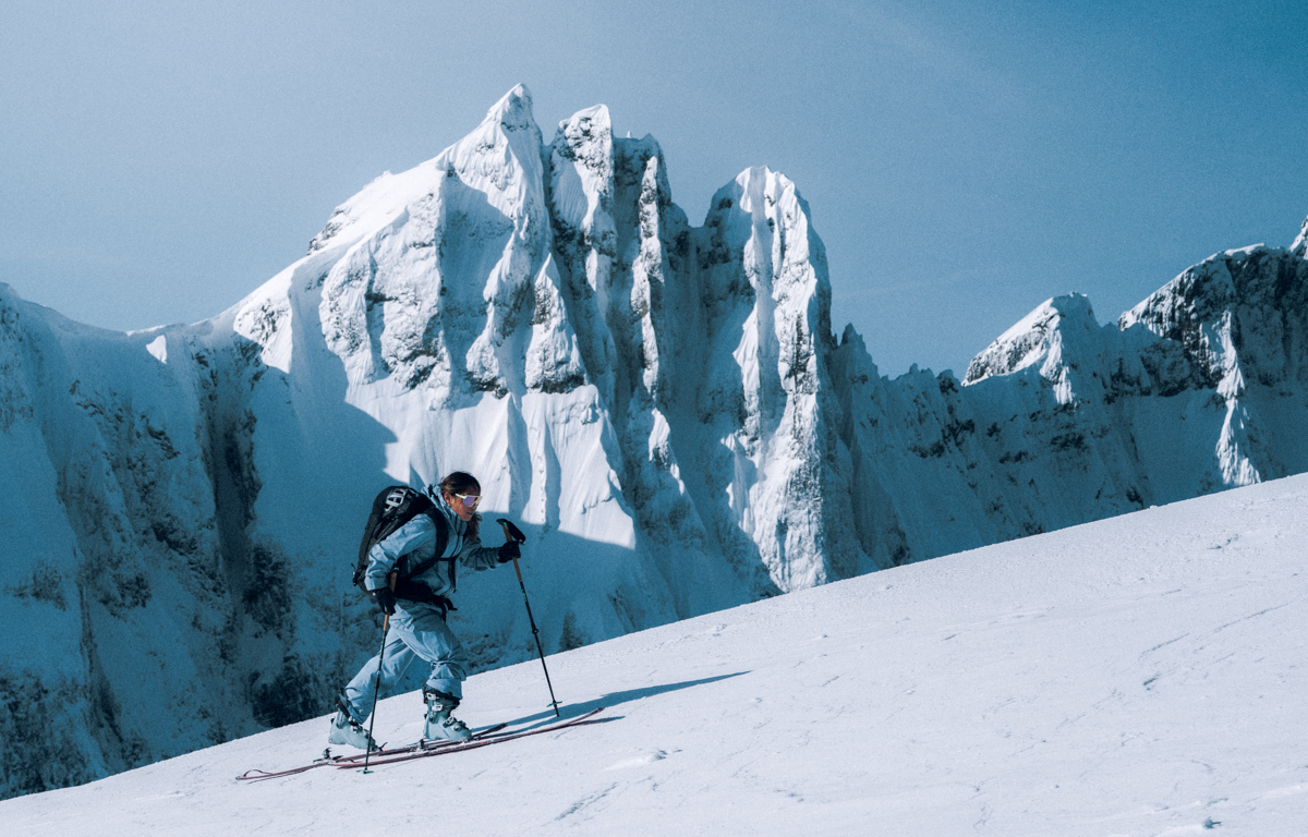 Gear tester wearing Patagonia Women's PowSlayer Pants and hardshell system, demonstrating fit and technical layering for alpine storm conditions. Ski Touring in Patagonia Gear