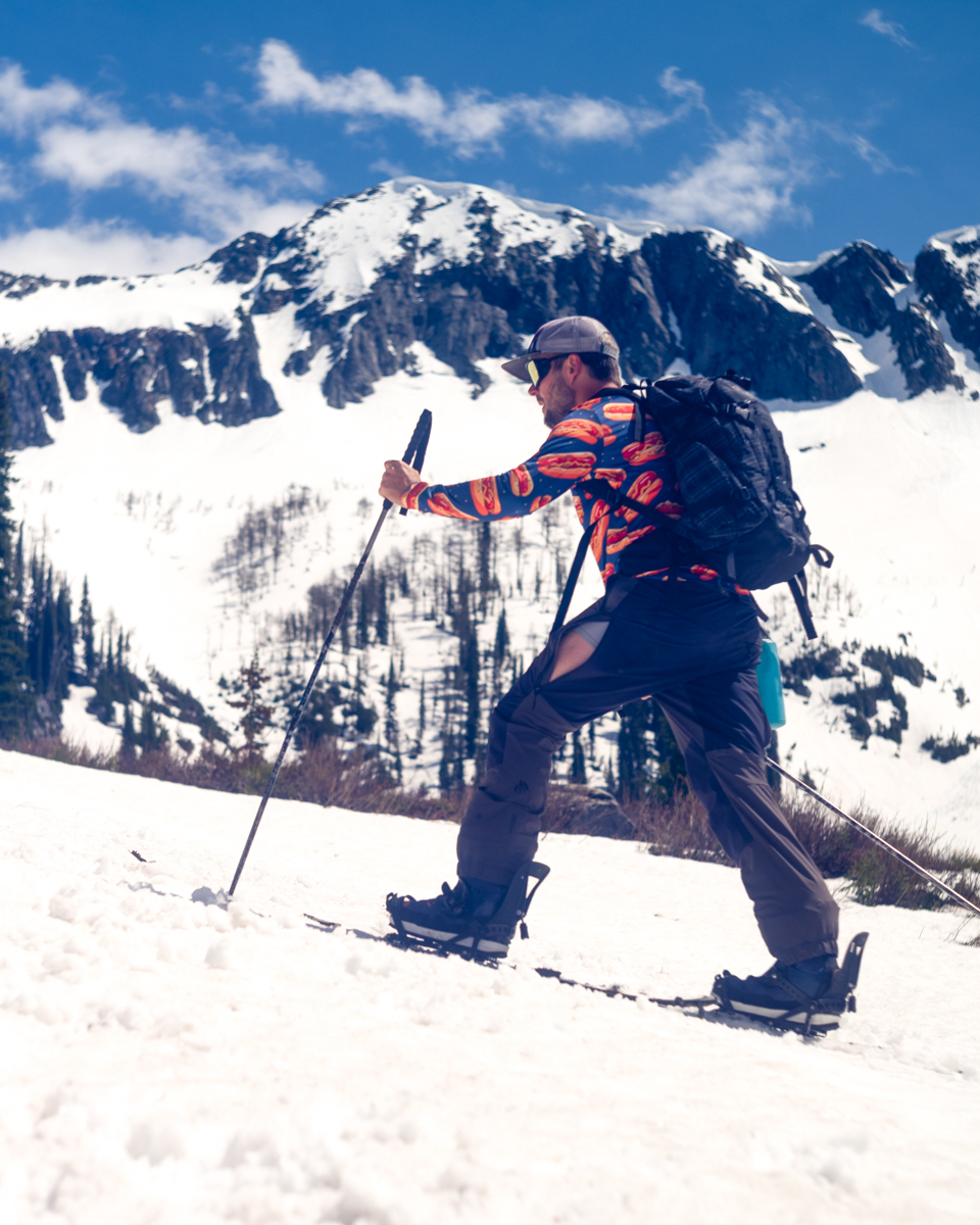 Man Splitboarding with Bright Shirt while Reviewing Sessions CO Shirt