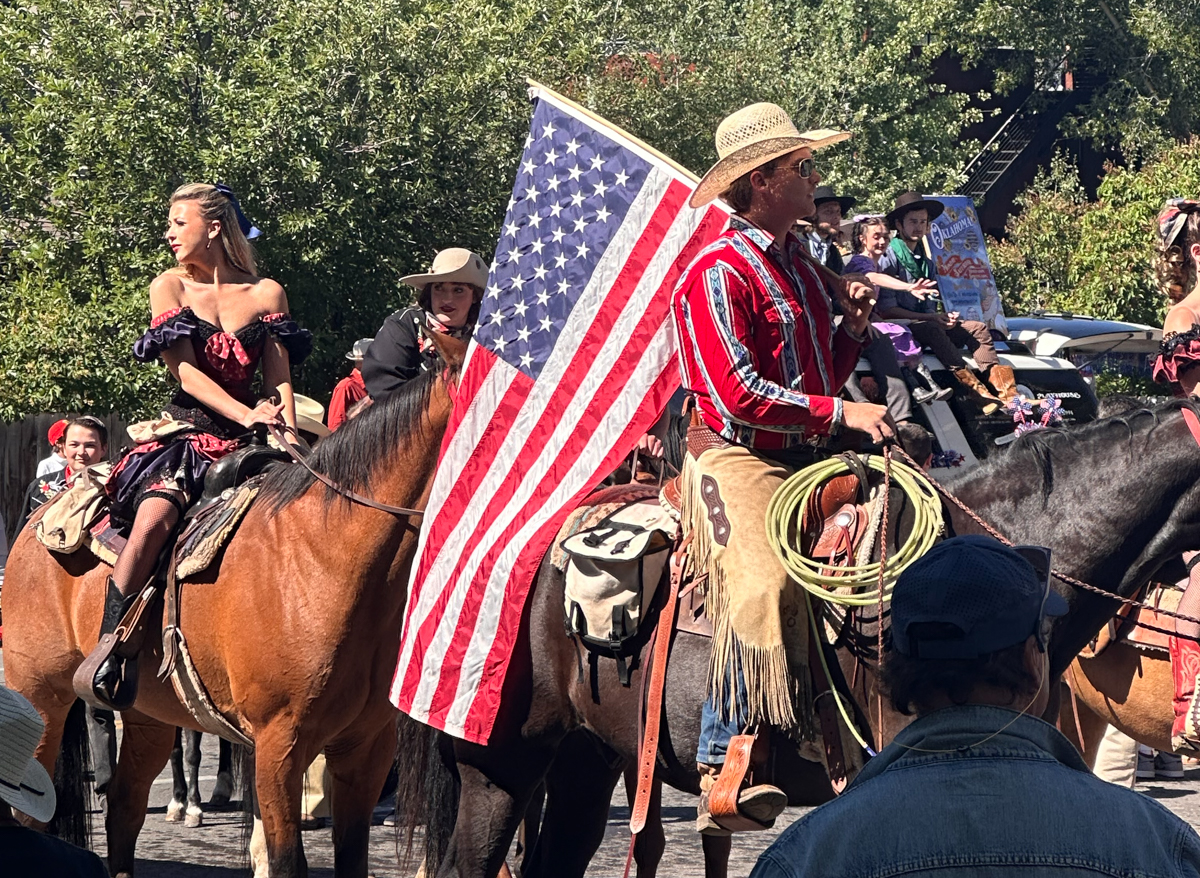 A rider carries the American flag onto the field at Jackson Hole Polo Club, where western heritage, horsemanship, and long-standing Wyoming traditions still shape summer life beneath the Tetons. | Photo: Mountain Weekly News