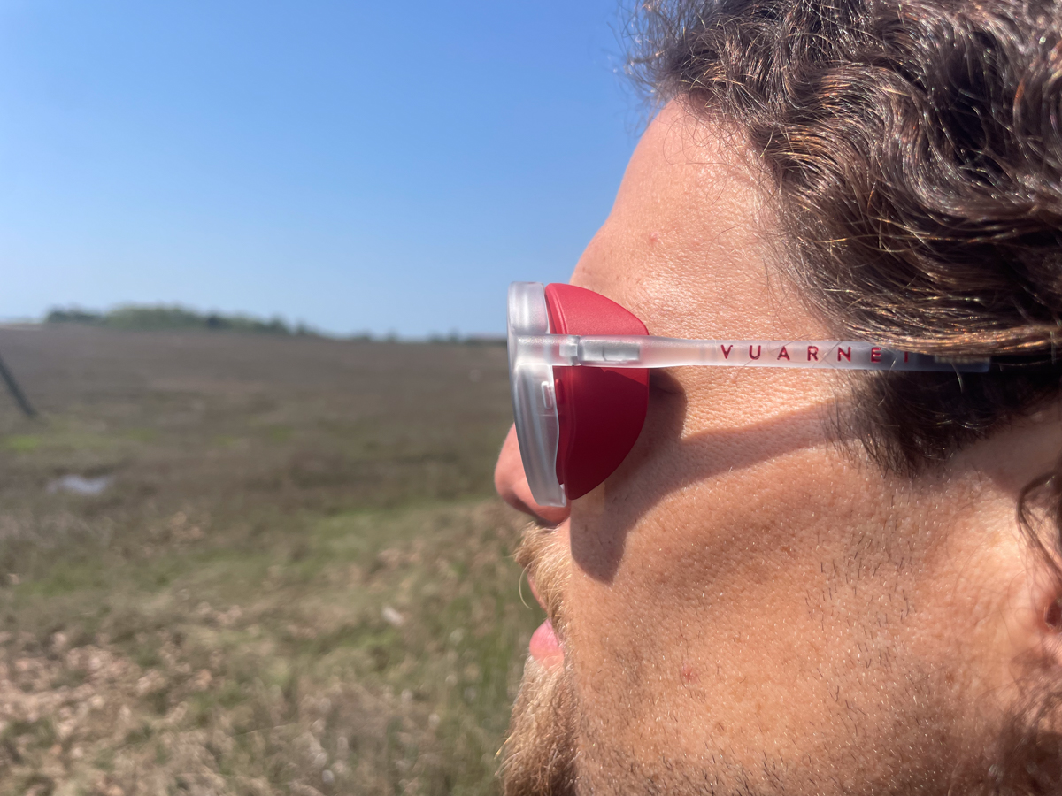 Close-up side profile of Vuarnet Ice Round sunglasses with Crystal Red frames and Grey Bluelynx lenses