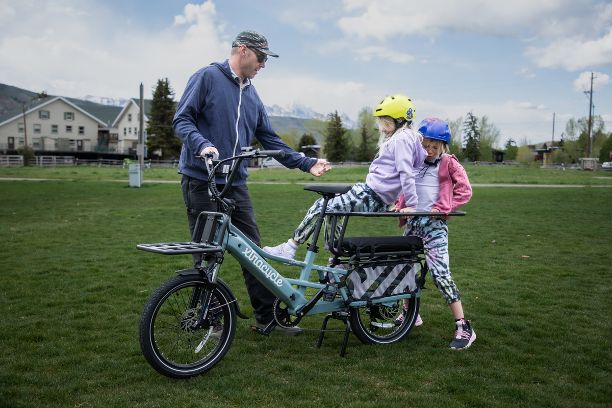 Eric Odlin’s daughters climb off the Xtracycle Hopper E-Bike after a fun family ride in Jackson Hole, WY. Caption: Eric Odlin’s girls having fun getting off the Xtracycle Hopper E-Bike after a family ride around