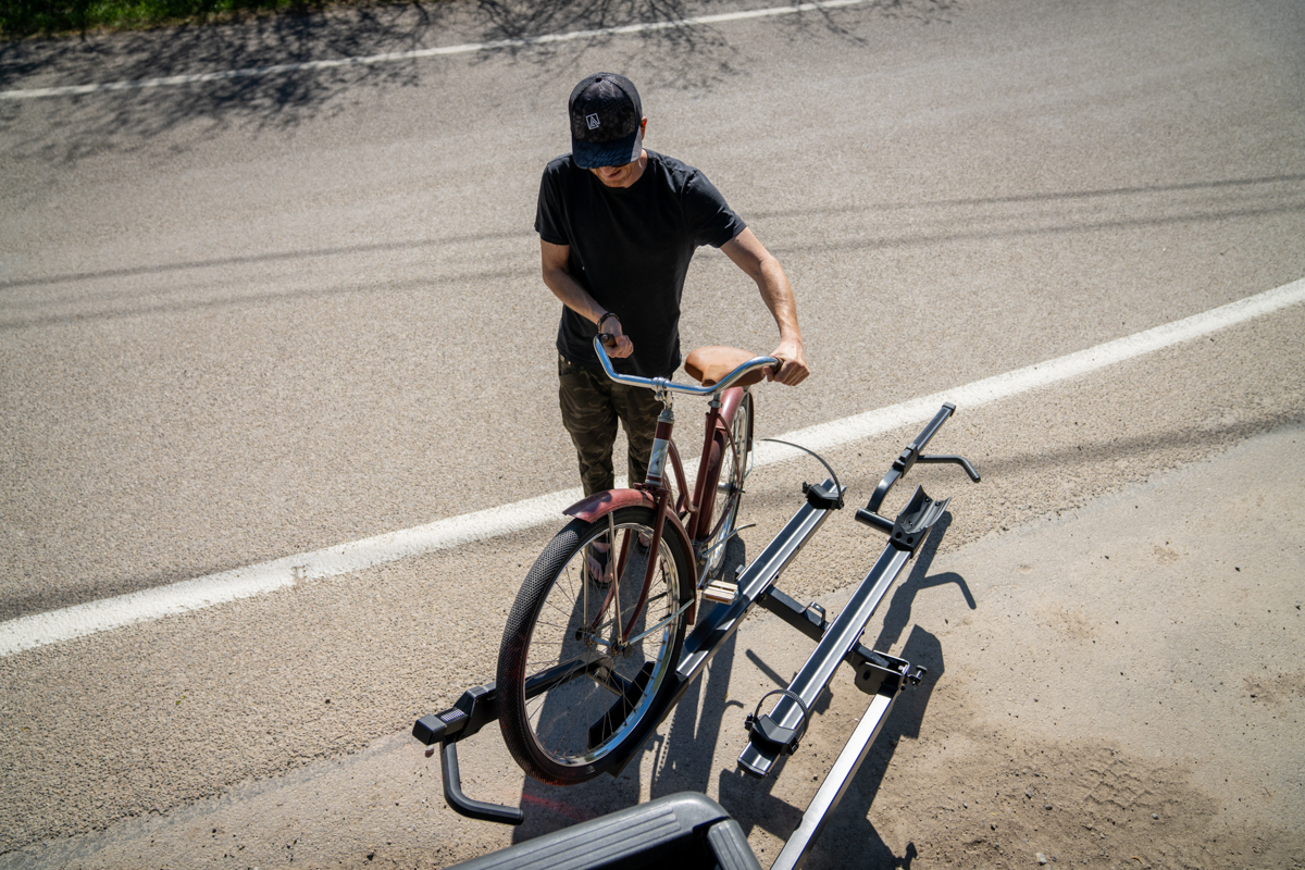 Mike Hardaker prepping bike for transport on Yakima StepUp Swing 2 inch rack