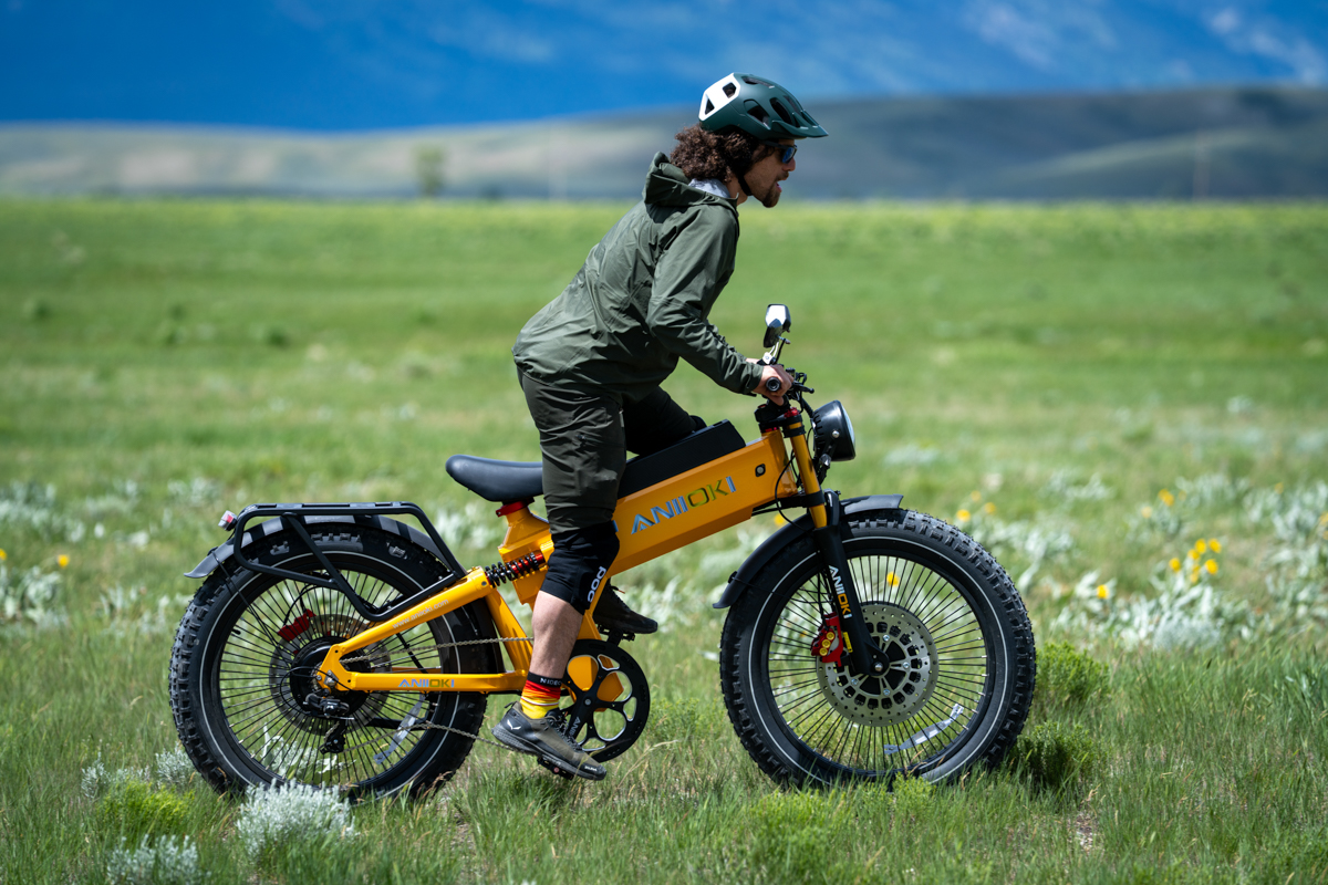 Pat Kinney riding the Aniioki A9 Pro Max e-bike with the Grand Tetons rising above Jackson Hole during TETON Tested review.