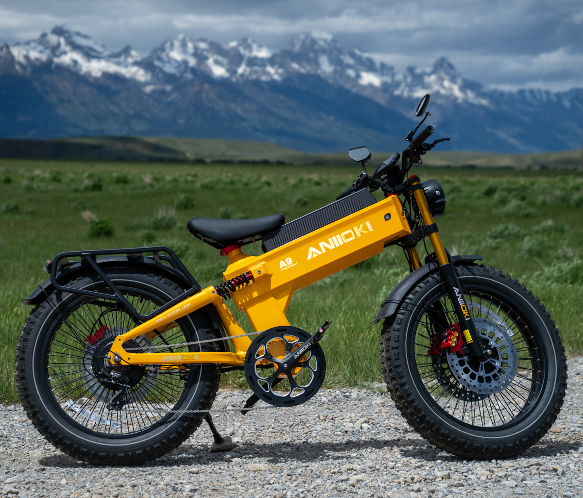 Aniioki A9 Pro Max dual motor e-bike parked beside the Grizzly Woody with the Teton Range towering above Jackson Hole.