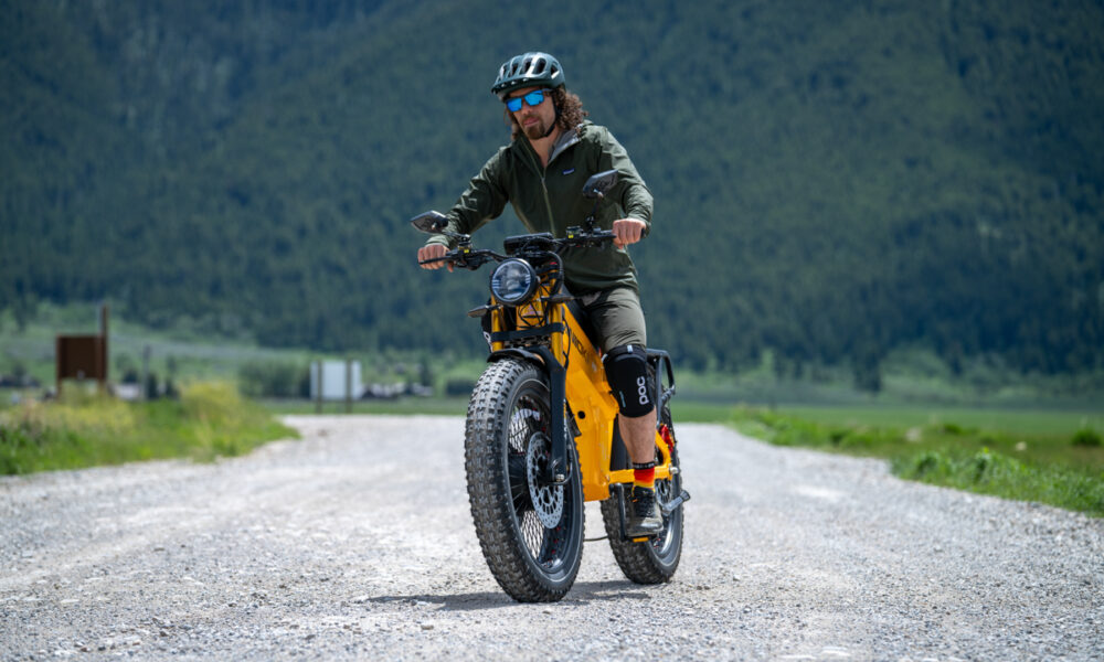 Pat Kinney testing the Aniioki A9 Pro Max dual motor e-bike on a gravel road beneath the Tetons near Jackson, Wyoming.