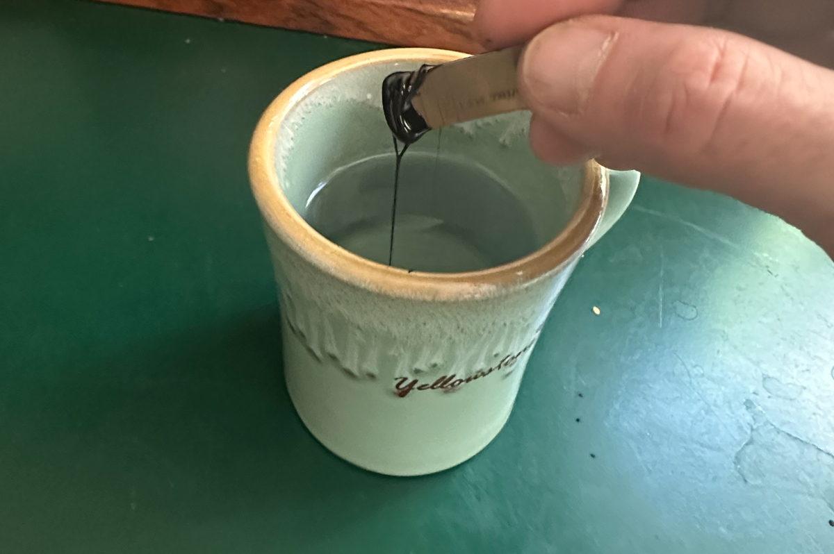 Pürblack True Gold shilajit resin being mixed into hot water during recovery and wellness testing in Jackson Hole, Wyoming
