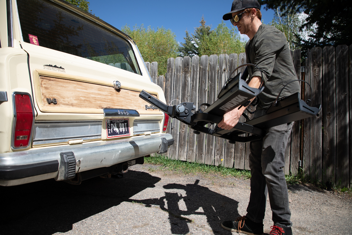 Mike Hardaker removing the integrated loading ramp from the Yakima OnRamp LX bike rack in Jackson Hole, Wyoming